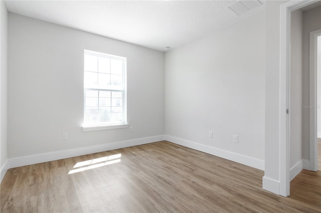 4409 Summer Flowers Pl, Kissimmee, FL 34746 - unfurnished room featuring wood finished floors, baseboards, and a textured ceiling