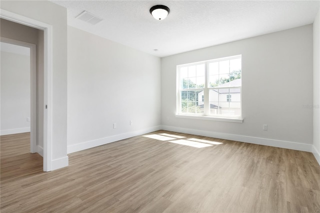 4409 Summer Flowers Pl, Kissimmee, FL 34746 - spare room featuring a textured ceiling, wood finished floors, visible vents, and baseboards