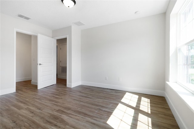 4409 Summer Flowers Pl, Kissimmee, FL 34746 - unfurnished bedroom with visible vents, baseboards, and wood finished floors