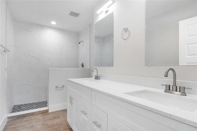 4409 Summer Flowers Pl, Kissimmee, FL 34746 - full bath with a sink, a marble finish shower, visible vents, and wood finished floors