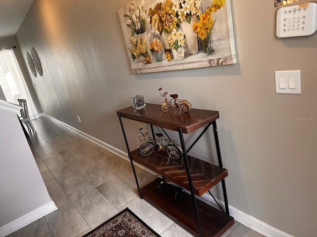 hall featuring baseboards