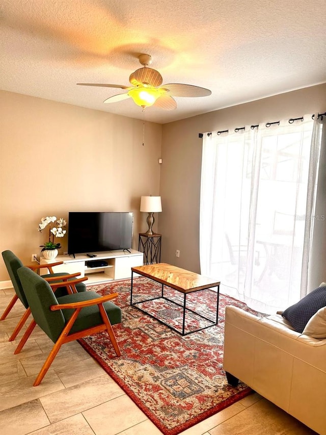 living room featuring a textured ceiling and ceiling fan