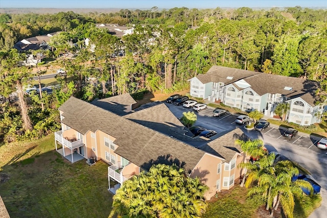 bird's eye view with a wooded view