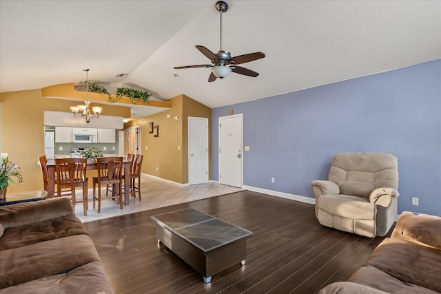 living room with visible vents, ceiling fan with notable chandelier, light wood-style floors, and vaulted ceiling