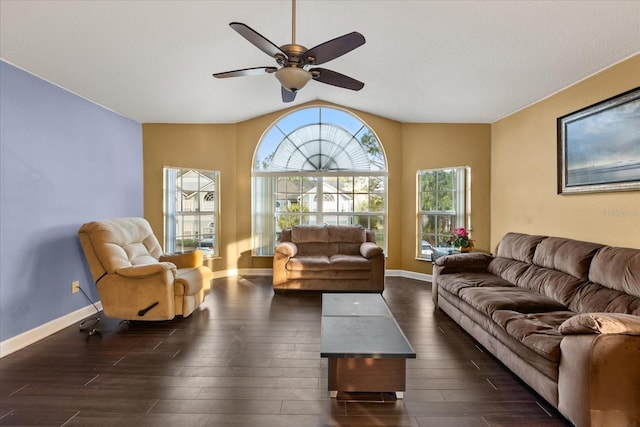 living area with baseboards, wood finished floors, a ceiling fan, and vaulted ceiling