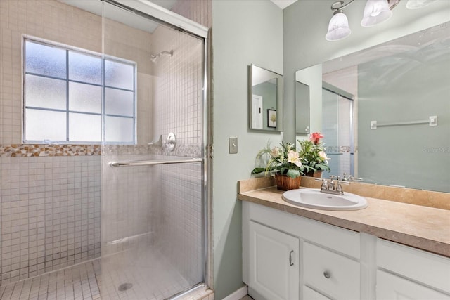 bathroom featuring vanity and a shower stall