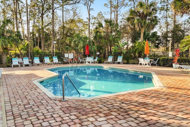 pool featuring a patio area and fence