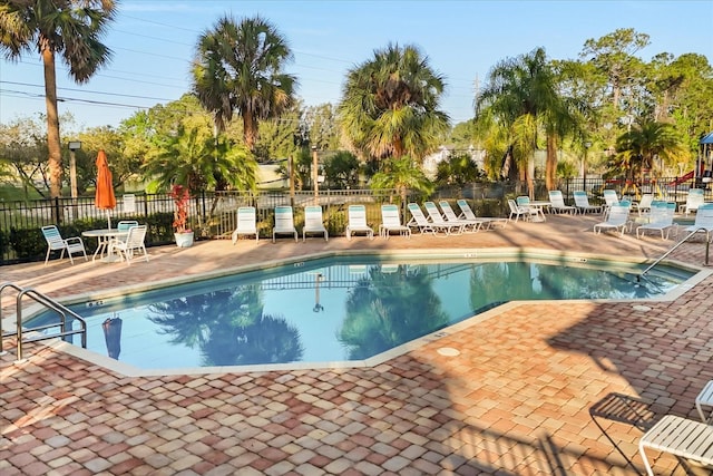 pool featuring a patio area and fence