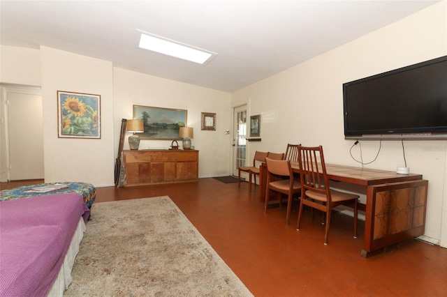 living area with concrete floors and vaulted ceiling