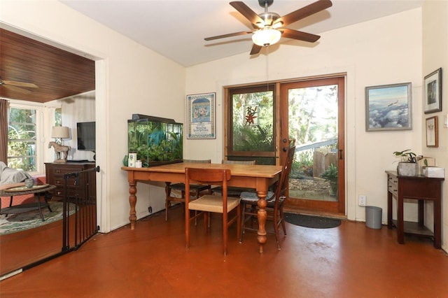 dining space featuring concrete flooring and a ceiling fan