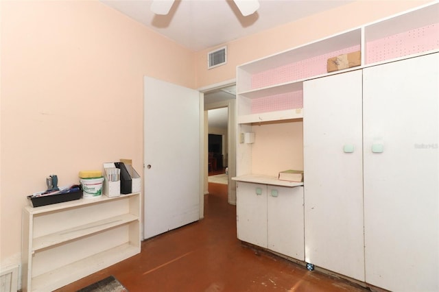 unfurnished bedroom with concrete floors, visible vents, and ceiling fan