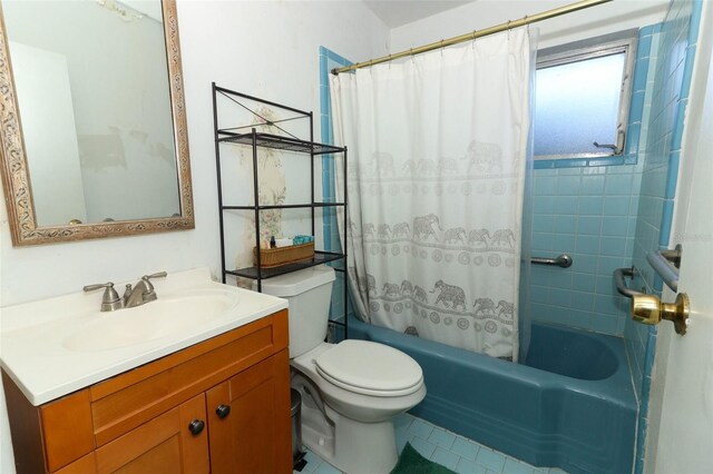 full bathroom featuring shower / tub combo, toilet, and vanity