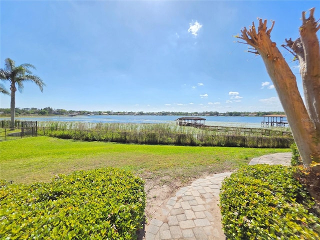 view of yard featuring a water view and fence