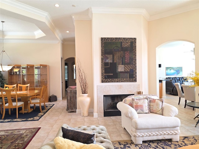 9137 Southern Breeze Dr, Orlando, FL 32836 - tiled living room featuring crown molding, arched walkways, recessed lighting, and a tile fireplace