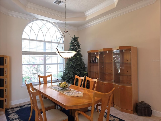 9137 Southern Breeze Dr, Orlando, FL 32836 - dining space with crown molding, a raised ceiling, baseboards, and visible vents