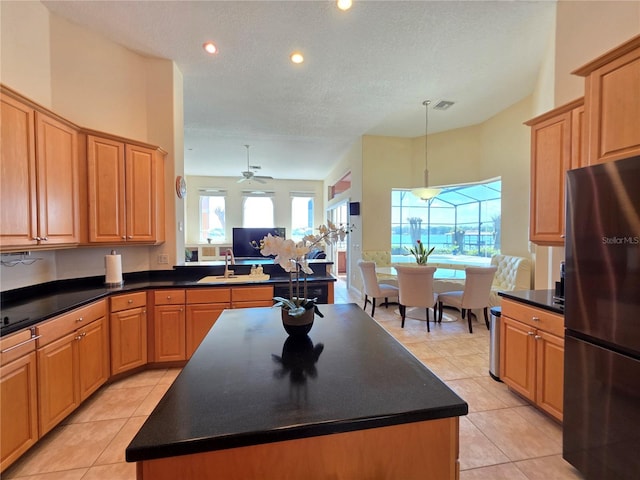 9137 Southern Breeze Dr, Orlando, FL 32836 - kitchen with freestanding refrigerator, dark countertops, open floor plan, and visible vents
