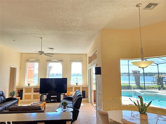 9137 Southern Breeze Dr, Orlando, FL 32836 - living room with light tile patterned floors, ceiling fan, a textured ceiling, and visible vents
