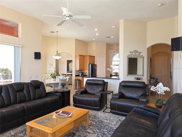 9137 Southern Breeze Dr, Orlando, FL 32836 - living area with arched walkways, a ceiling fan, a high ceiling, and a healthy amount of sunlight