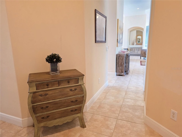 9137 Southern Breeze Dr, Orlando, FL 32836 - hall featuring light tile patterned floors, arched walkways, and baseboards