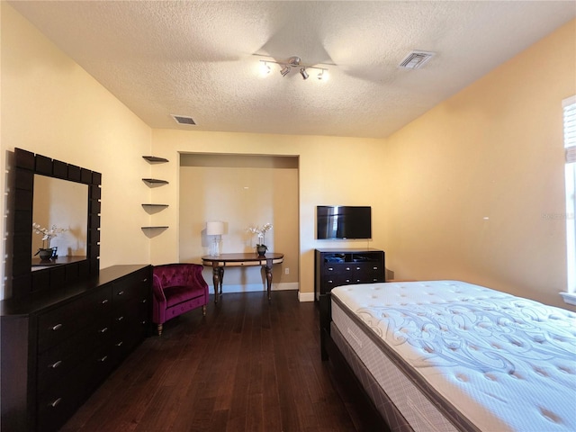 9137 Southern Breeze Dr, Orlando, FL 32836 - bedroom with a textured ceiling, visible vents, and dark wood-style floors