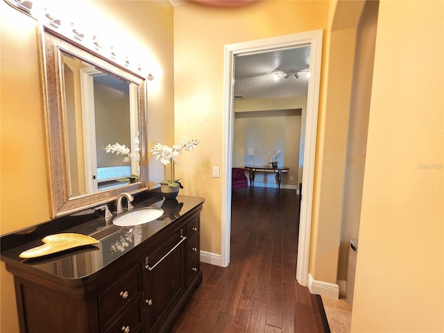 9137 Southern Breeze Dr, Orlando, FL 32836 - bathroom featuring baseboards, vanity, and wood finished floors