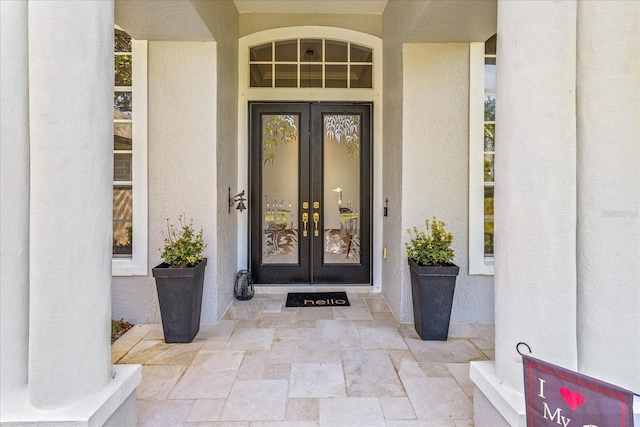 entrance to property with french doors and stucco siding