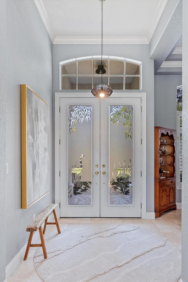 entrance foyer featuring crown molding, french doors, and baseboards