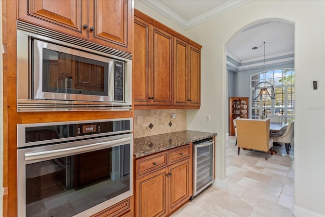 kitchen with wine cooler, ornamental molding, dark stone countertops, arched walkways, and stainless steel appliances