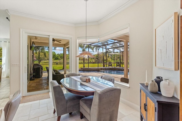 dining space featuring baseboards, a ceiling fan, crown molding, and a sunroom