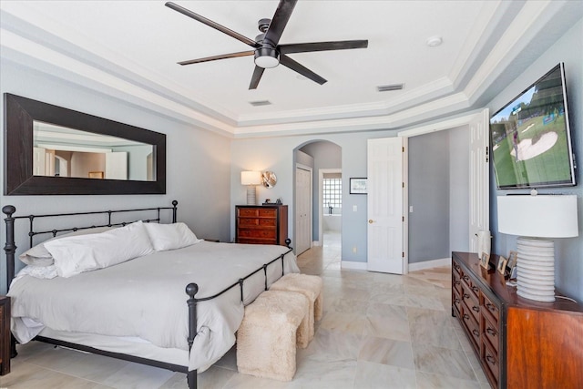 bedroom featuring visible vents, arched walkways, a raised ceiling, and ornamental molding