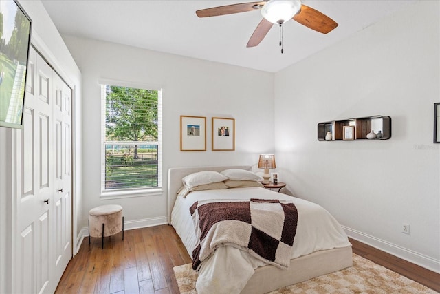 bedroom featuring a closet, ceiling fan, baseboards, and hardwood / wood-style flooring