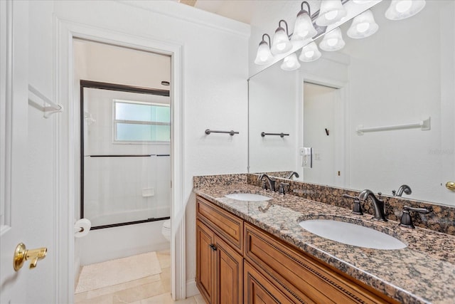 bathroom featuring tile patterned flooring, double vanity, toilet, and a sink