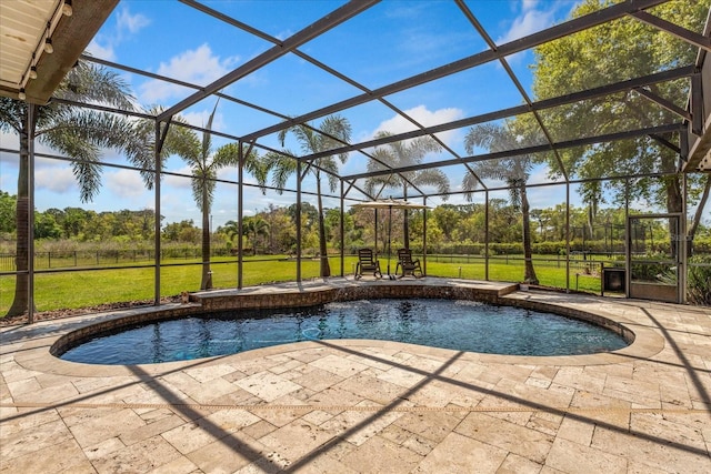 pool with a yard, a patio, and glass enclosure