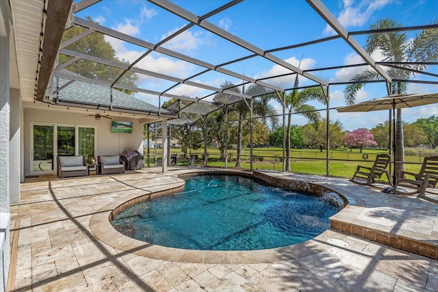 pool with a yard, a patio, a lanai, and a ceiling fan