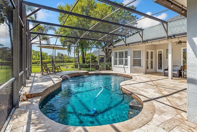 outdoor pool featuring a patio area, a lanai, and a ceiling fan