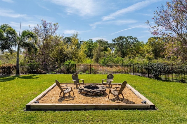 view of yard featuring an outdoor fire pit and fence