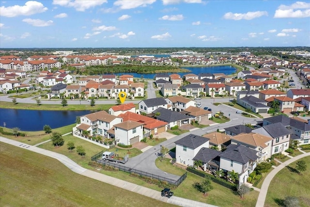 drone / aerial view featuring a residential view and a water view