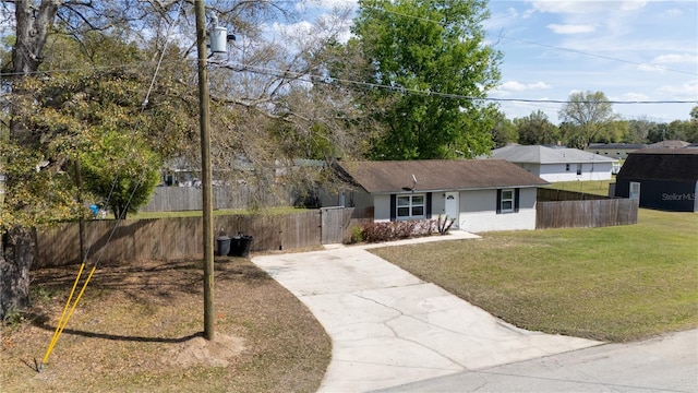 ranch-style house with stucco siding, driveway, a front yard, and fence