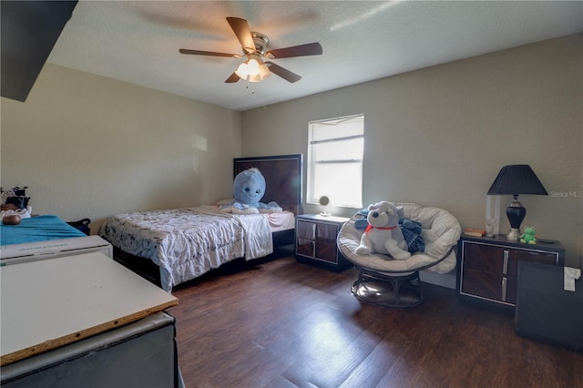 bedroom with a textured ceiling, wood finished floors, and a ceiling fan