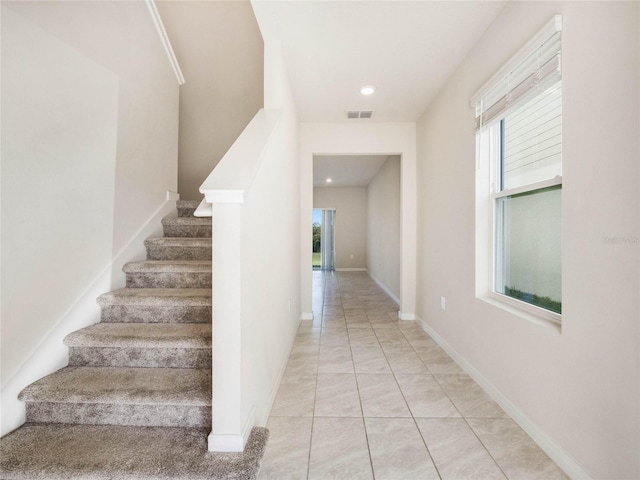 staircase with recessed lighting, baseboards, visible vents, and a wealth of natural light