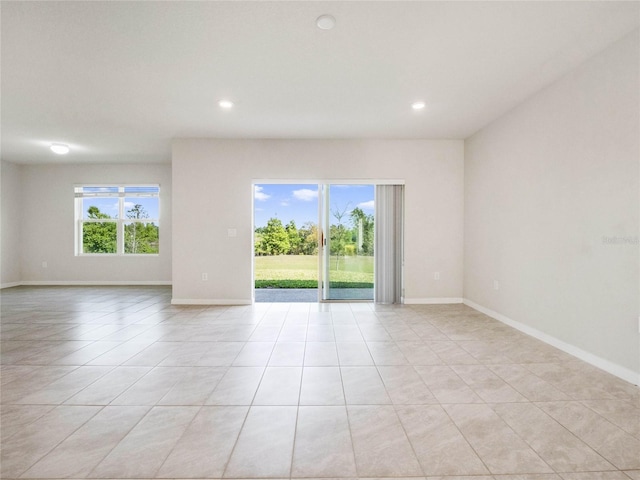 unfurnished room with recessed lighting, baseboards, and light tile patterned floors