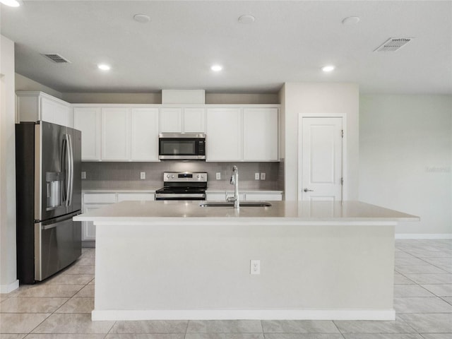 kitchen featuring a sink, visible vents, appliances with stainless steel finishes, and light countertops