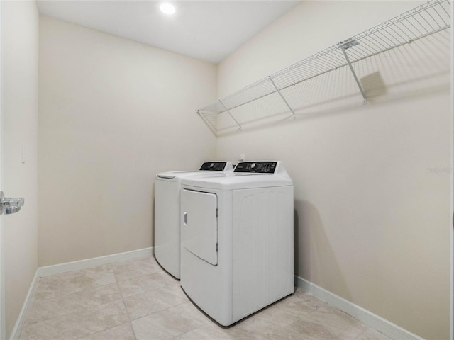 laundry room featuring laundry area, baseboards, and washer and clothes dryer