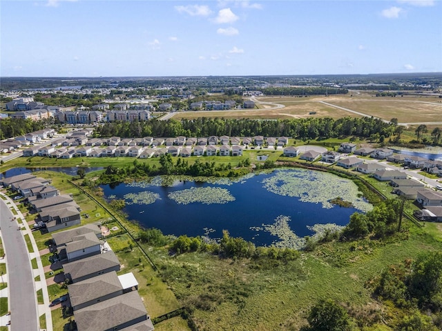 drone / aerial view with a water view and a residential view