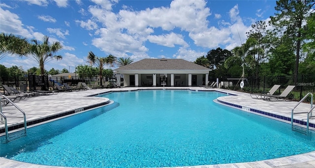 community pool featuring a patio and fence