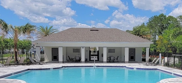 community pool featuring a patio and fence