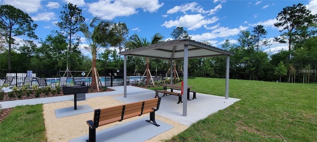 surrounding community with a lawn, a patio, fence, a gazebo, and a pool