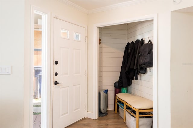 mudroom with crown molding and wood finished floors