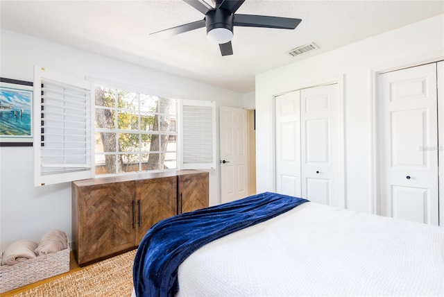 bedroom with a ceiling fan, visible vents, and a closet