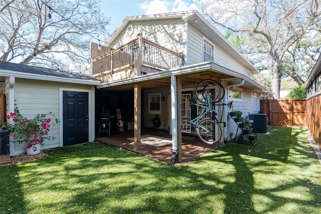 back of house with cooling unit, fence, a lawn, and a wooden deck